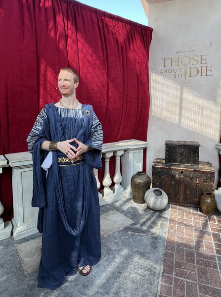 A man in a blue toga