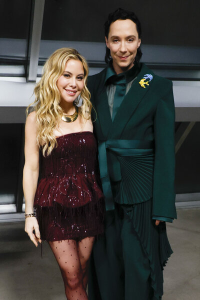 Tara Lipinski and Johnny Weir smile together at the the 2026 Milan Cortina Olympics.