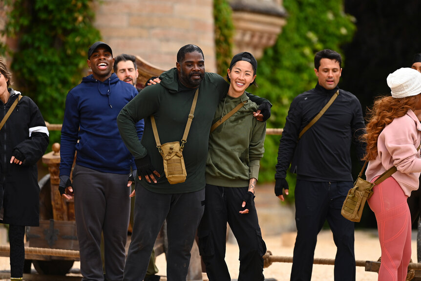 Ron Funches and Kristen Kish outside of the Traitors castle in Scottland