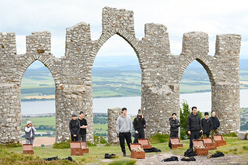 Candiace Dillard Bassett, Lisa Rinna, Colton Underwood, Rob Rausch, Mark Ballas, Eric Nam, Stephen Colletti, Maura Higgins, and Johnny Weir with boxes scattered in The Traitors Season 4 Episode 7.