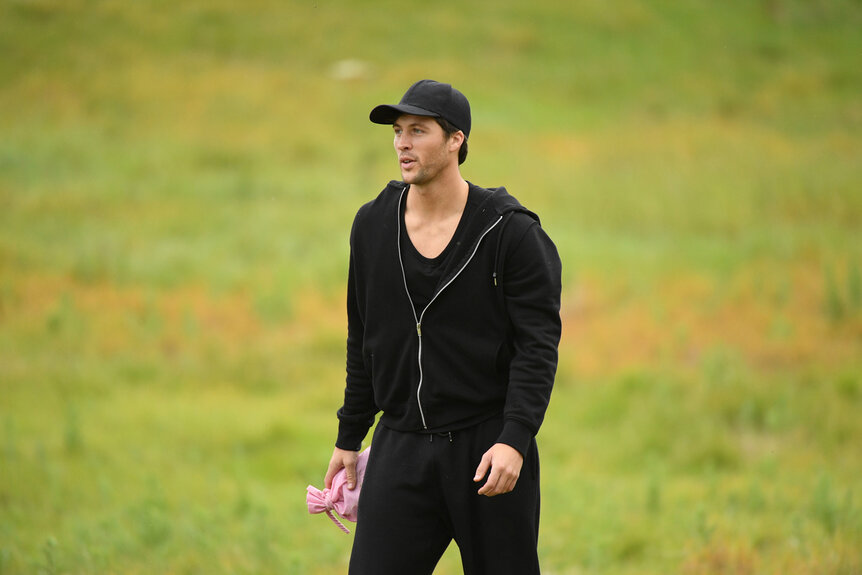 Rob Rausch walking on a grass field during The Traitors Season 4 Episode 10.