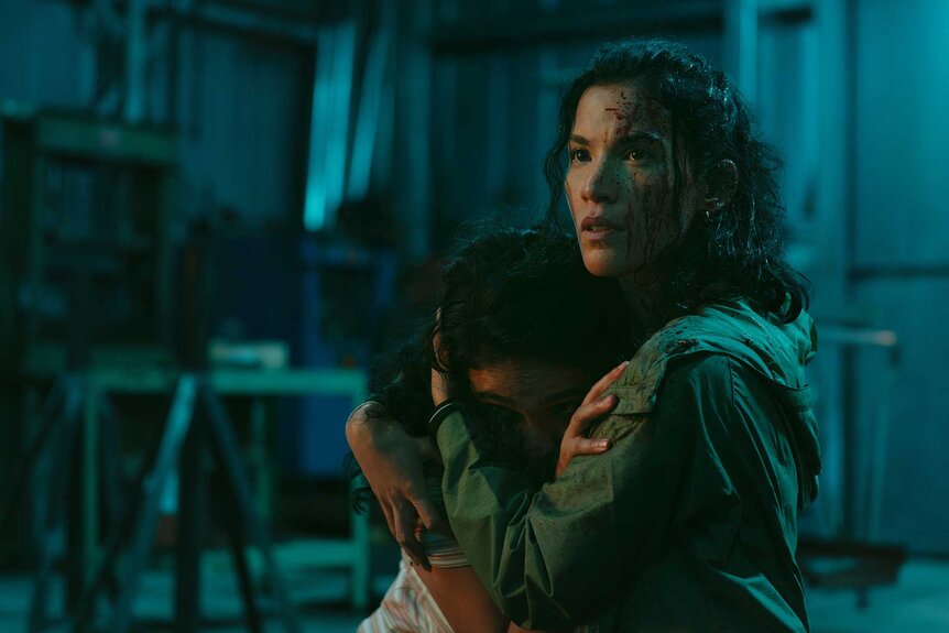 Leah holding someone in M.I.A. Season 1 Episode 2.
